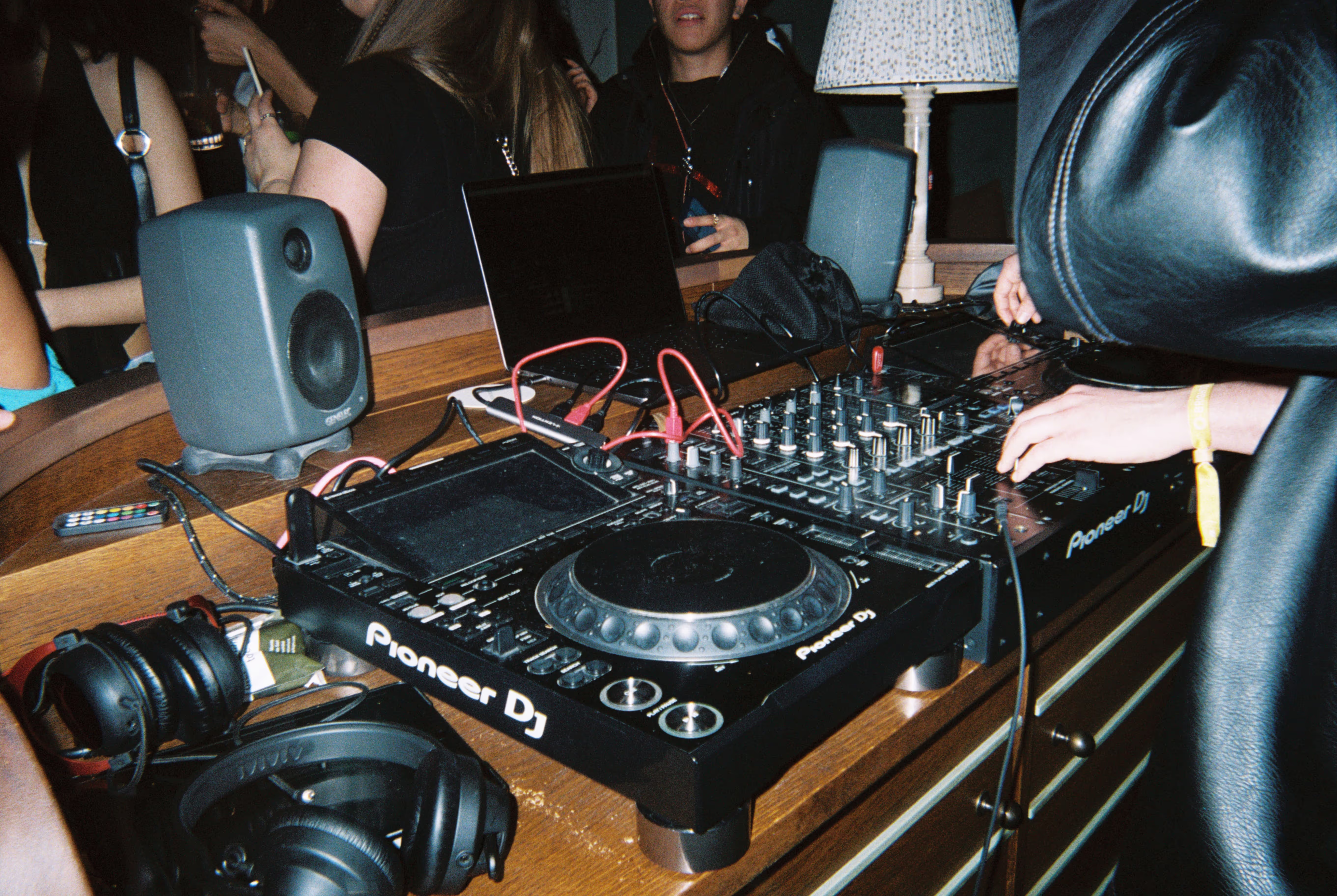 A DJ's deck with other gear and the crowd in the background at the Soirée's event in Brighton, UK