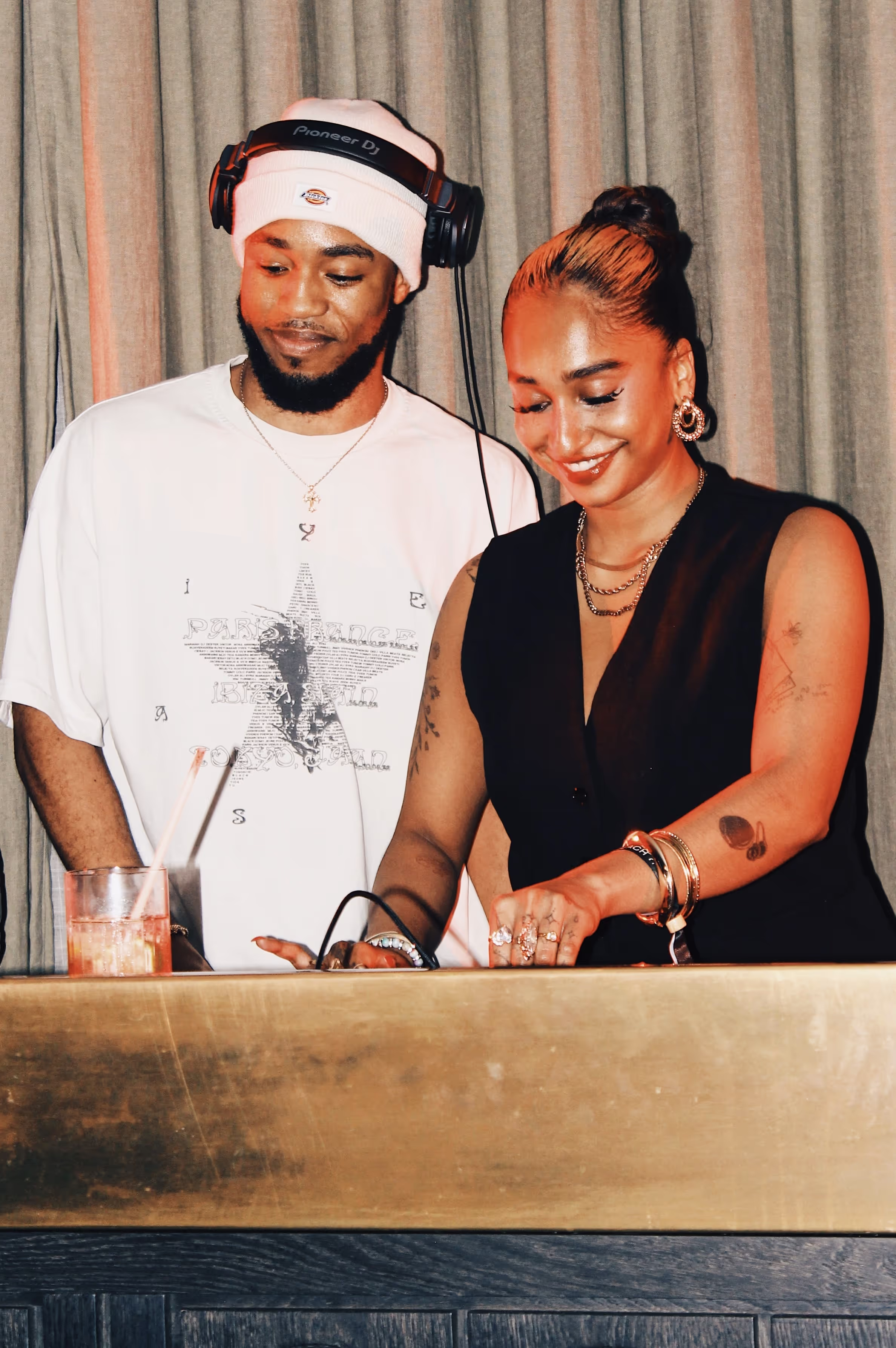 Two smiling DJs having fun at the Soirée & GRADUATION Records collaboration event at Beach House, Brighton, UK