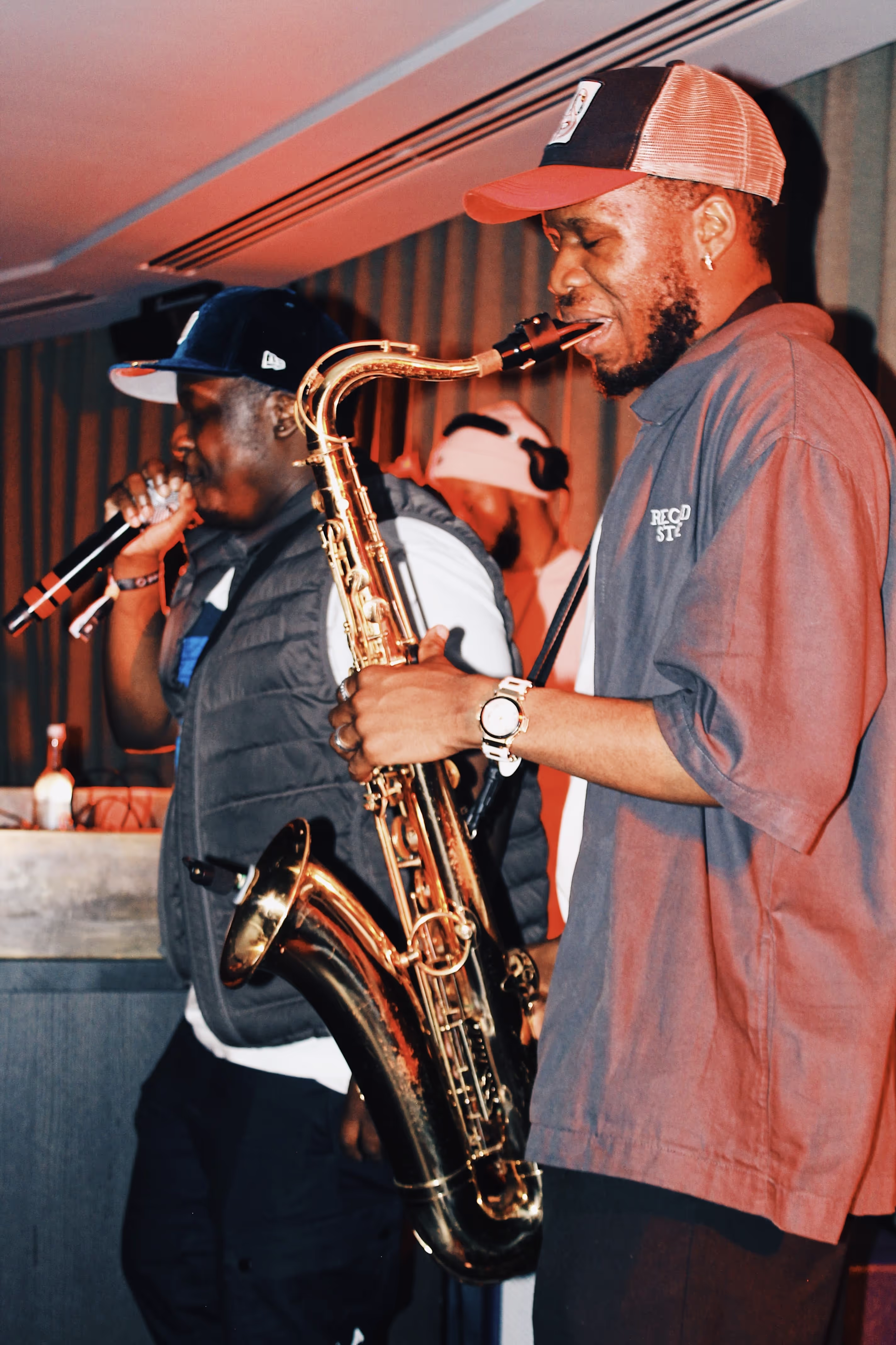 A saxophonist and his band in the middle of a song, performing at the Soirée & GRADUATION Records collaboration event at Beach House, Brighton, UK