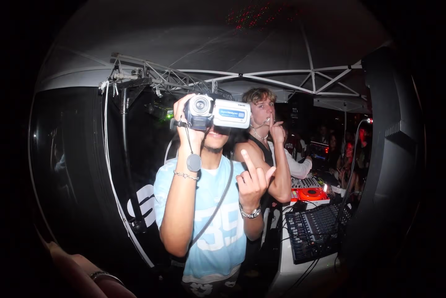 A fish-eye photo of a cameraman and DJ having fun at Soirée's party at Paris Fashion Week 2024