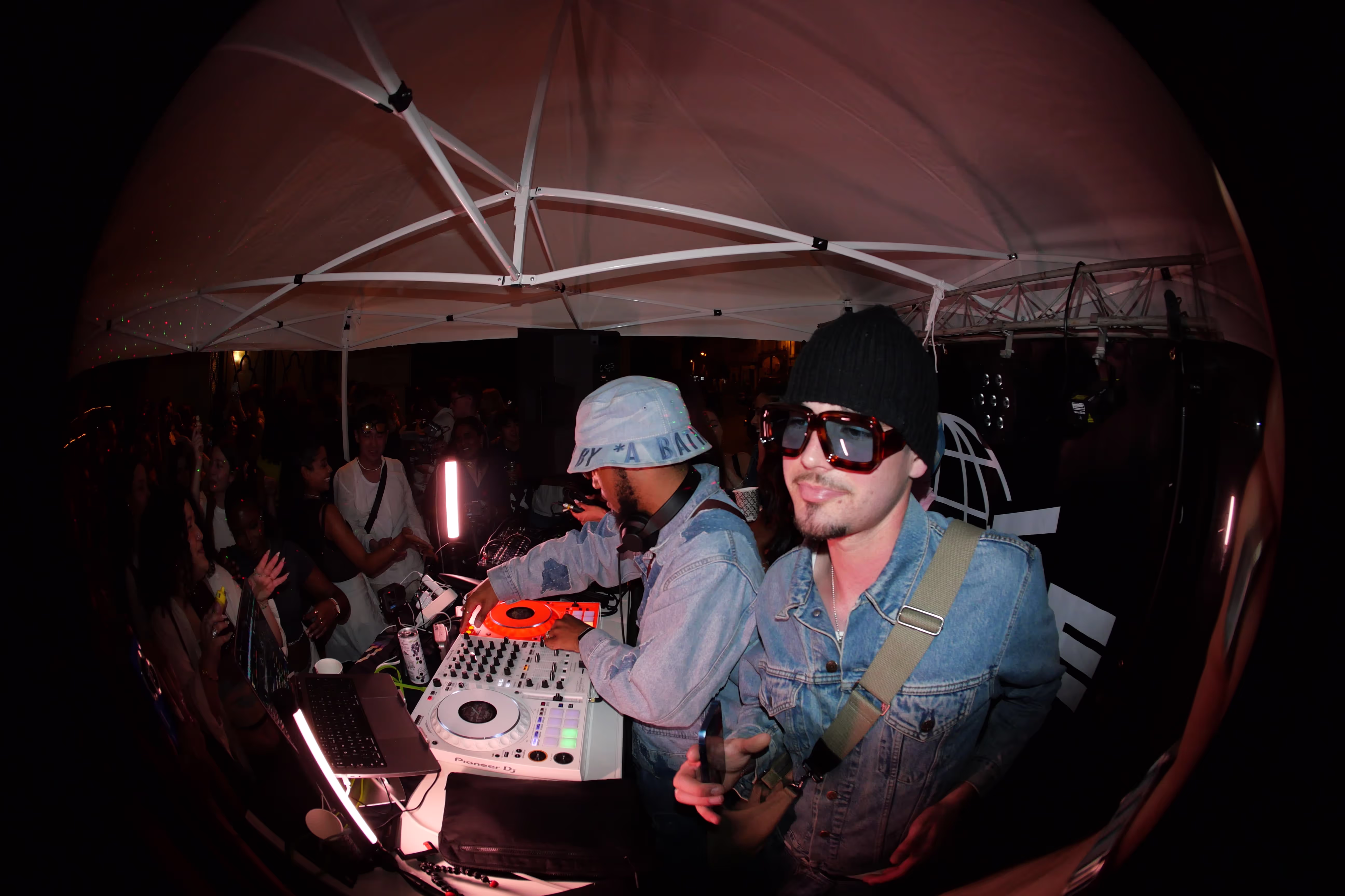 Fish-eye photo of two DJs playing back-to-back music sets at a Soirée's party at Paris Fashion Week 2024