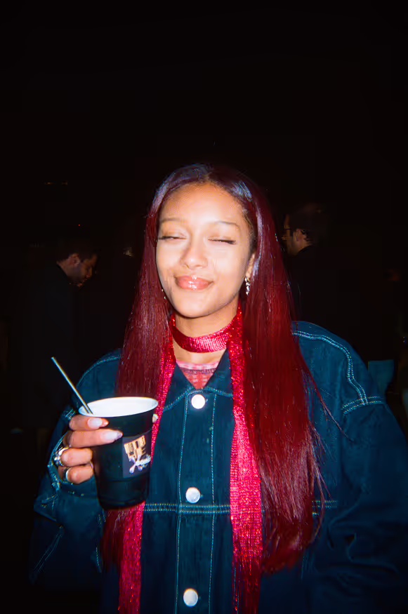 A young woman posing at a rooftop party by Soirée in London, UK