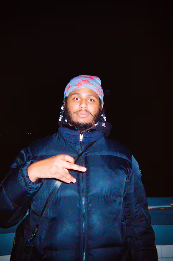 A young man posing at a rooftop party by Soirée in London, UK