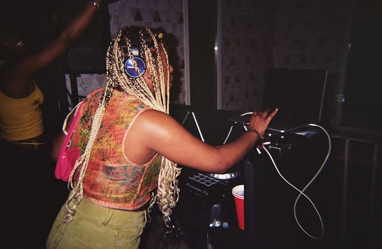 A DJ playing her music set at Soirée's "Back To The Roots" house party in Brighton, UK