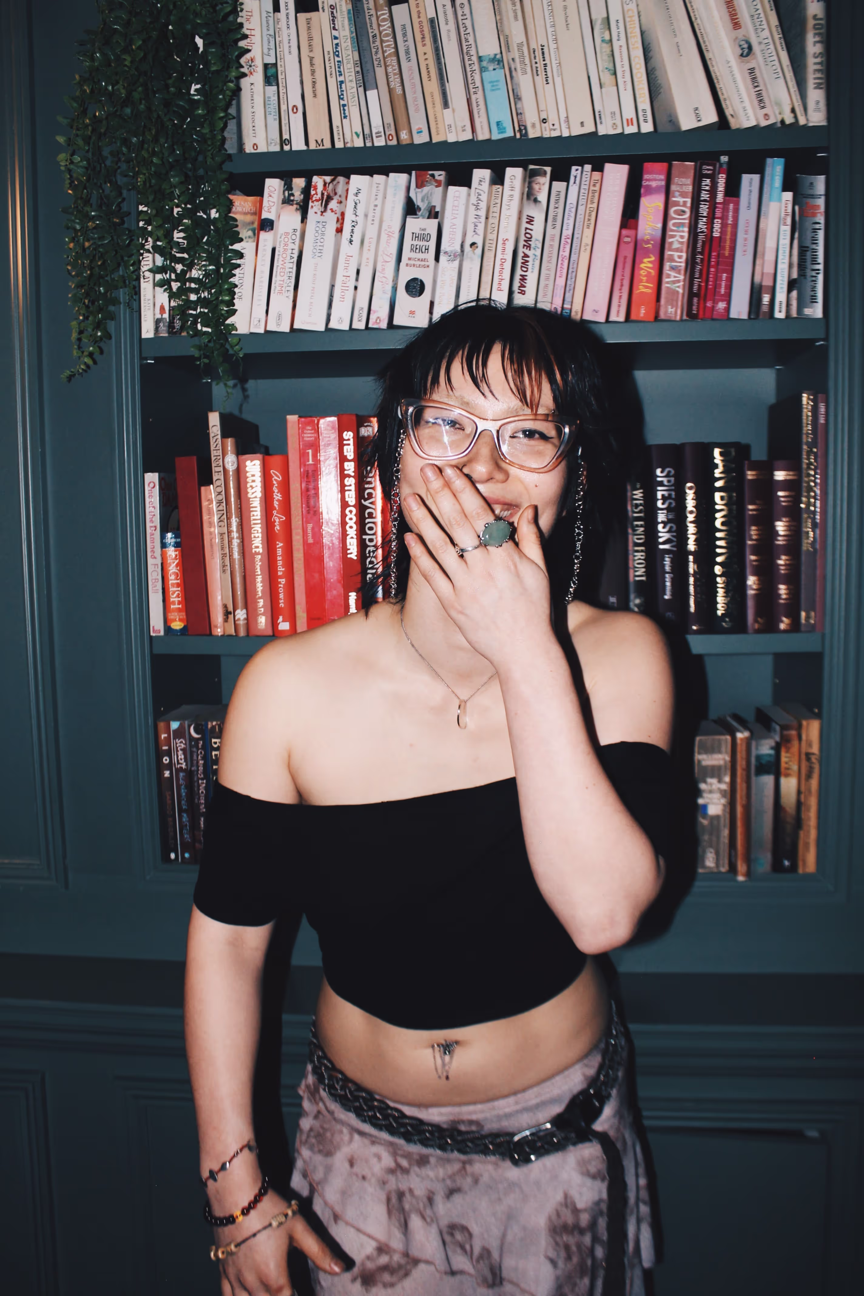 A young woman posing at a party at a collaboration party by Soirée, Doppelgängers, and Serene Collective at the library in London, UK