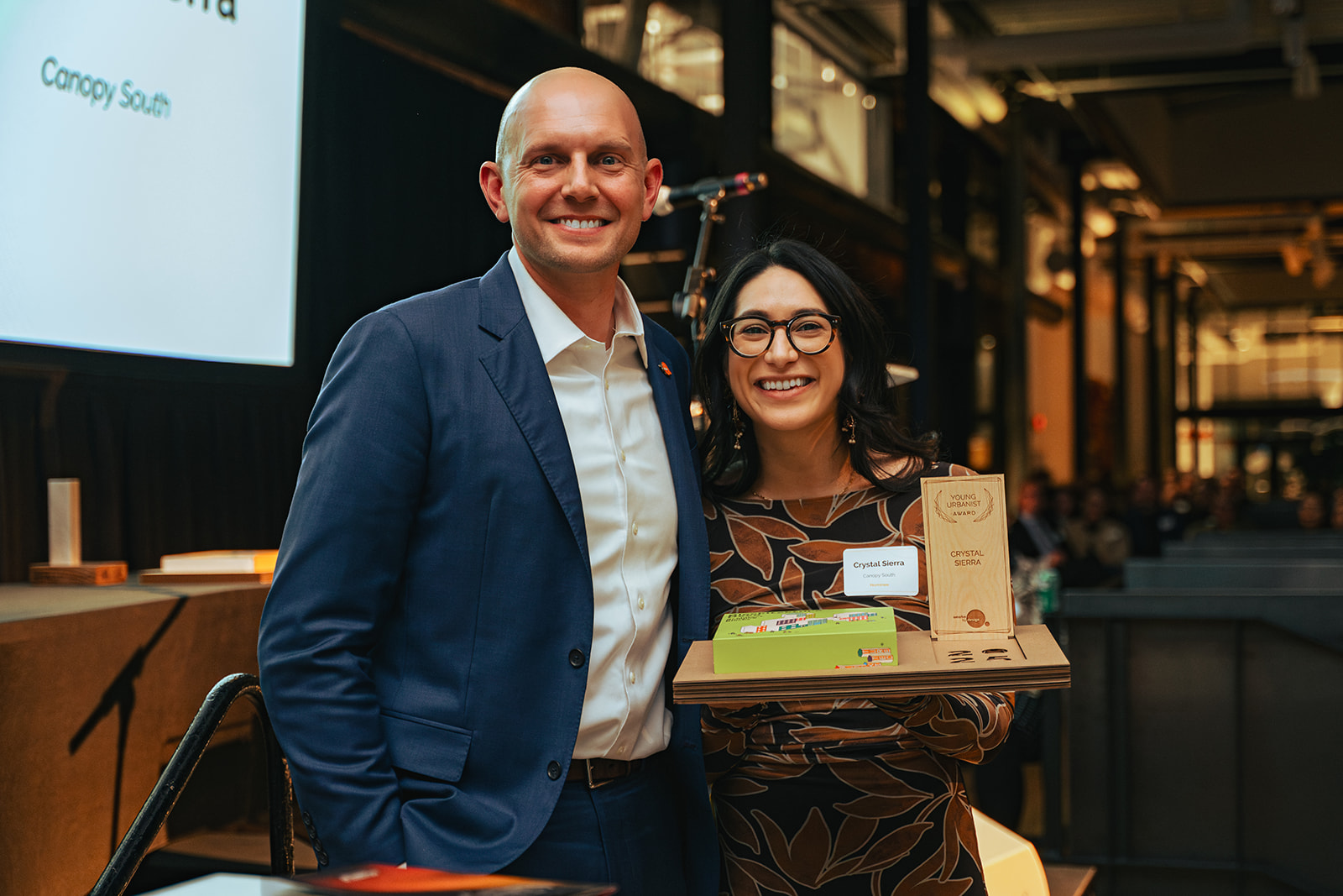 Two volunteers in blue shirts smiling