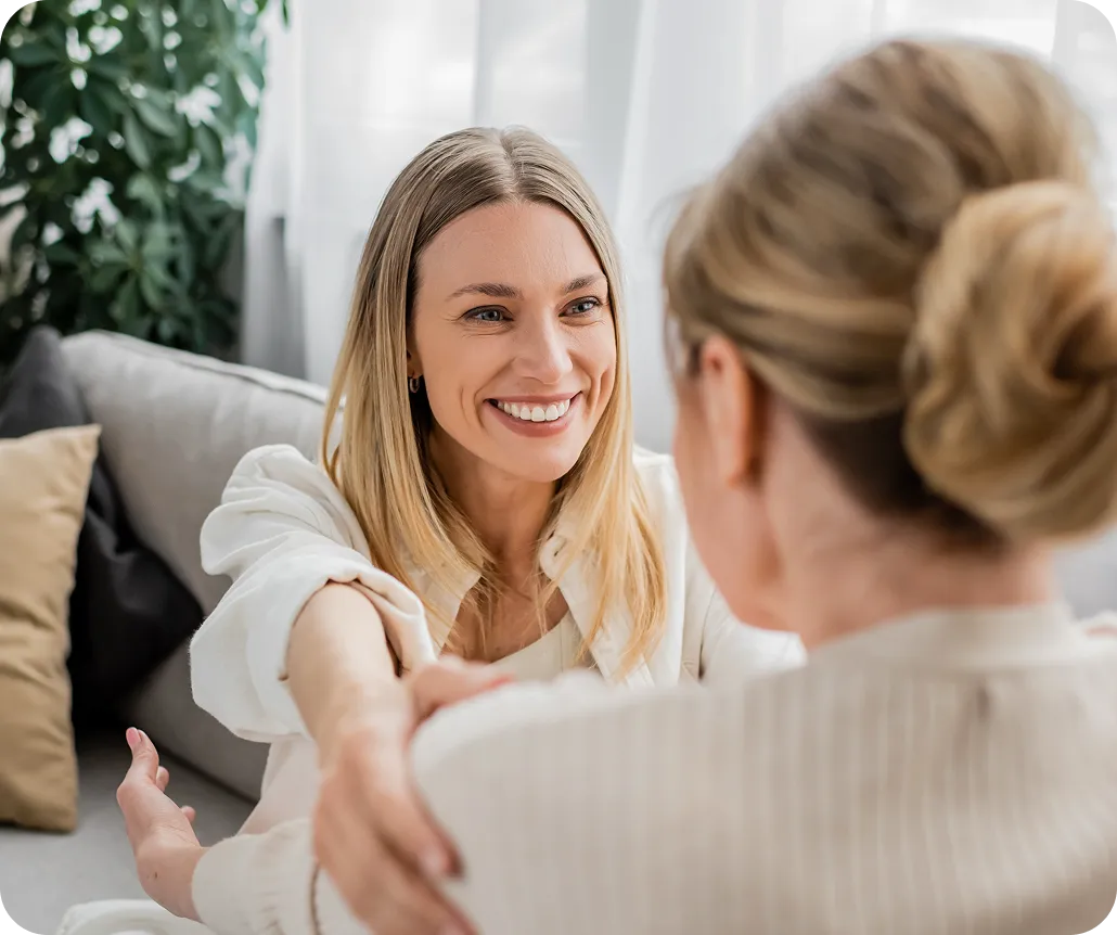 Smiling woman offering comfort and support during a conversation.