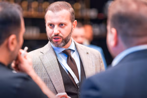 a man in a suit talking to another man