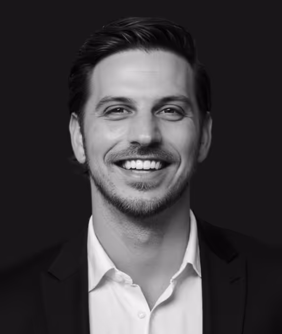 Mike Loretz in a suit against a dark background.