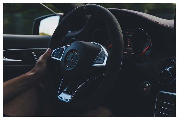 Person behind wheel driving car