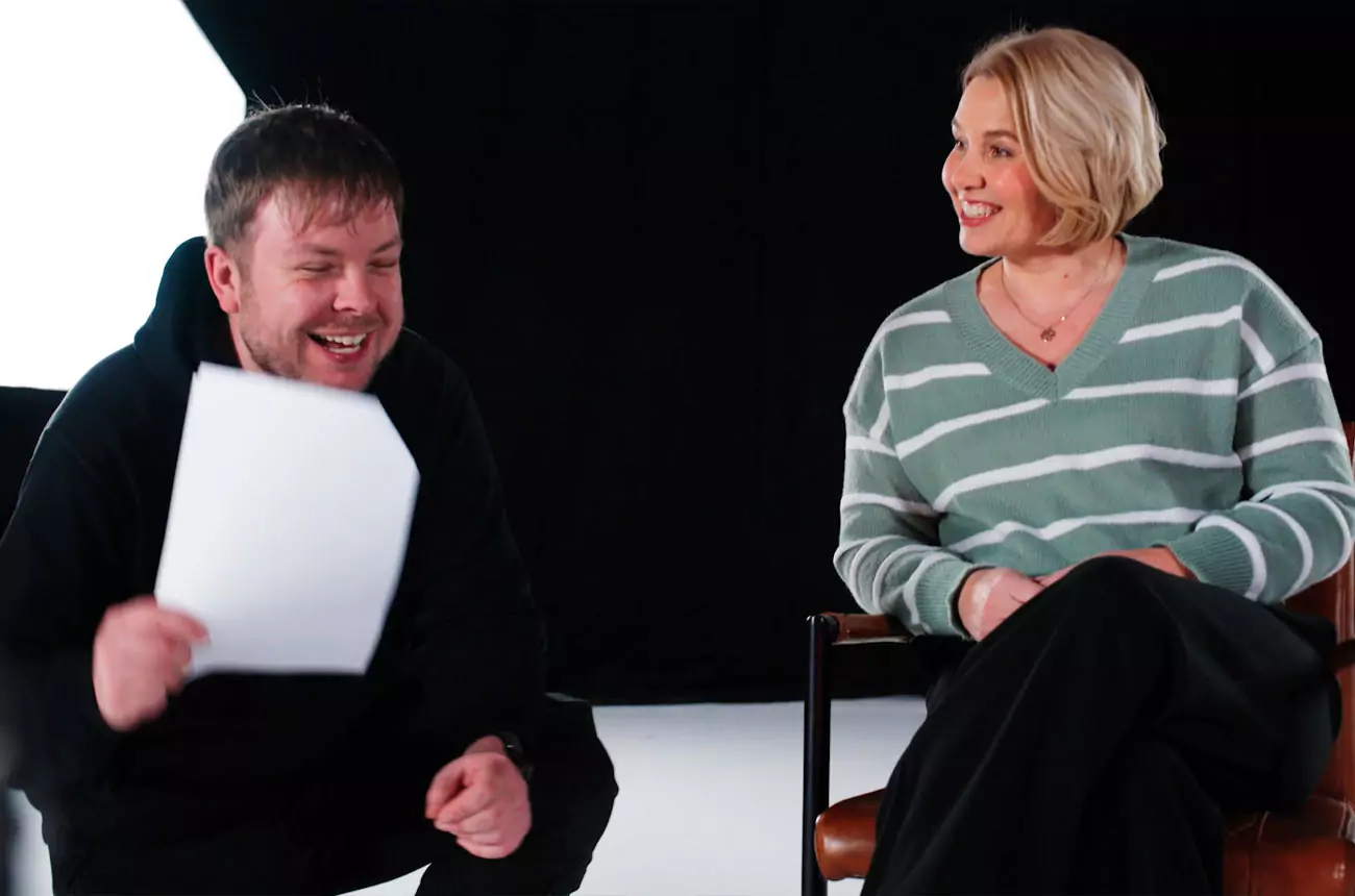 GNG Studios camera operator laughing on set with a client during a relaxed and collaborative moment of filming.