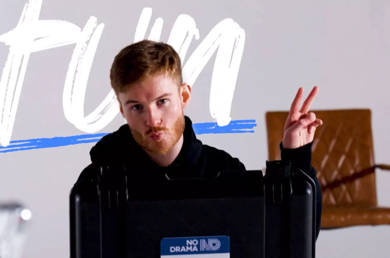 Dan from GNG Studios throwing a peace sign while standing behind a camera case on set.