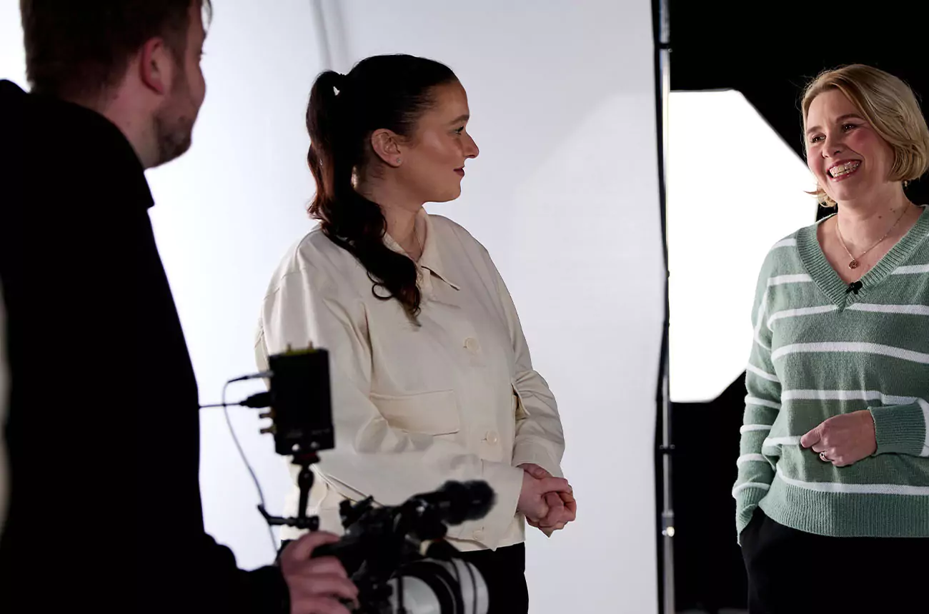 GNG Studios crew chatting with client on set during a relaxed moment between takes.