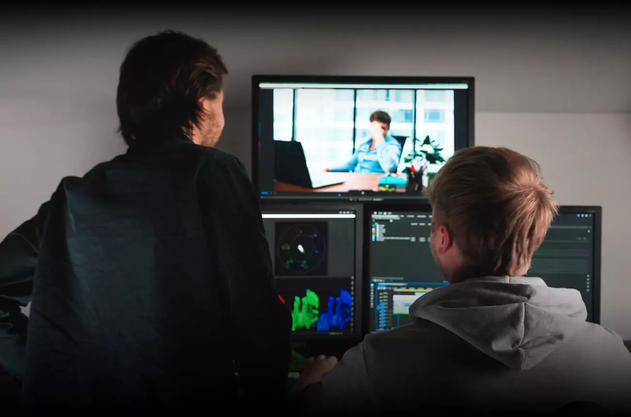 GNG Studios editing team reviewing footage in post-production, with colour grading and timeline tools visible on screen.