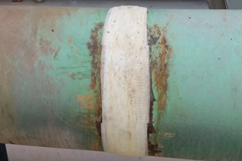 UPS PipeWrap bandage freshly applied to corroded leaking pipe for emergency repair