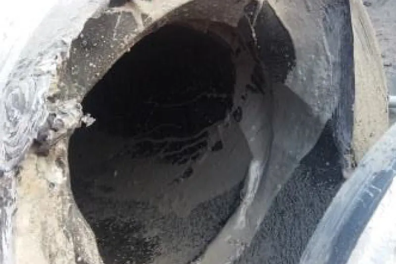 Severely damaged large-diameter pipe showing complete structural failure