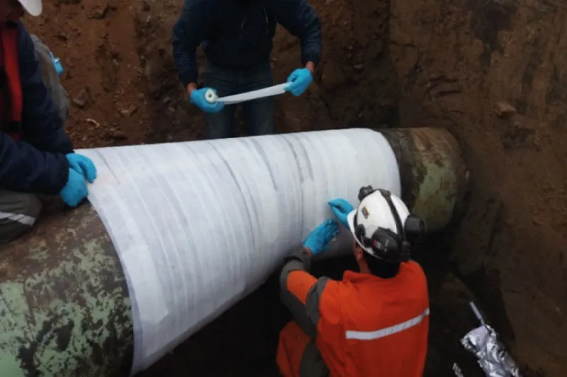 Engineers applying UPS Emergency Pipe Repair Bandage to damaged pipeline