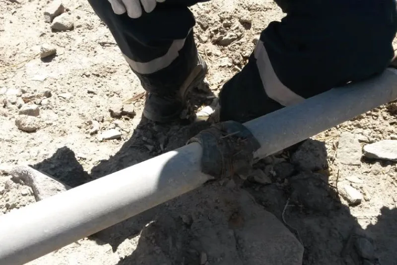 Close-up of cured UPS Stick Grade epoxy plug successfully sealing pipe leak