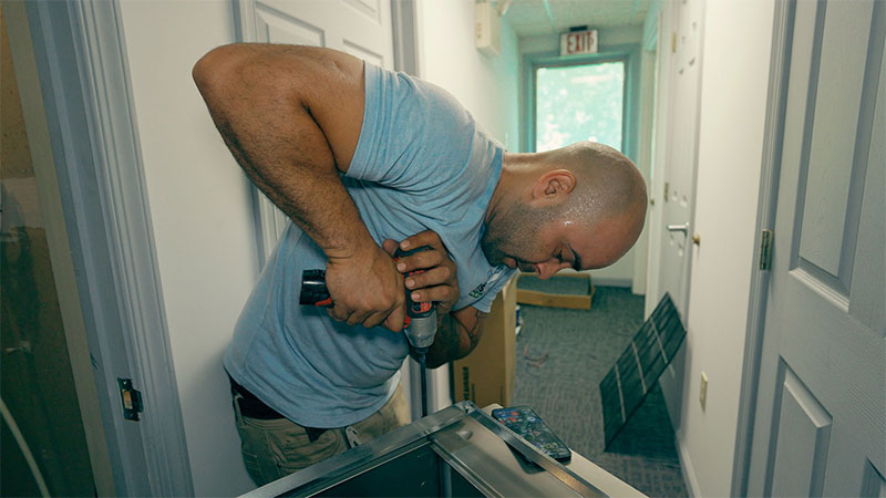 Certified HVAC technician repairing a furnace unit in Bucks County, PA