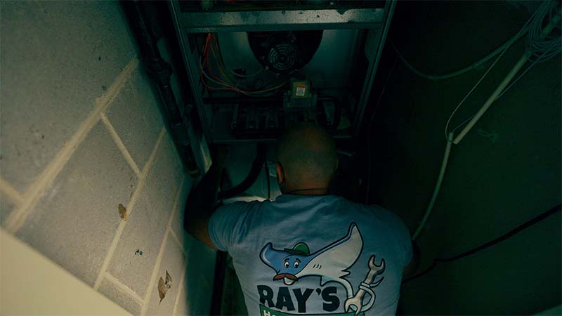 Ray's Heating and Air expert HVAC technician working on an HVAC unit in Bensalem, PA