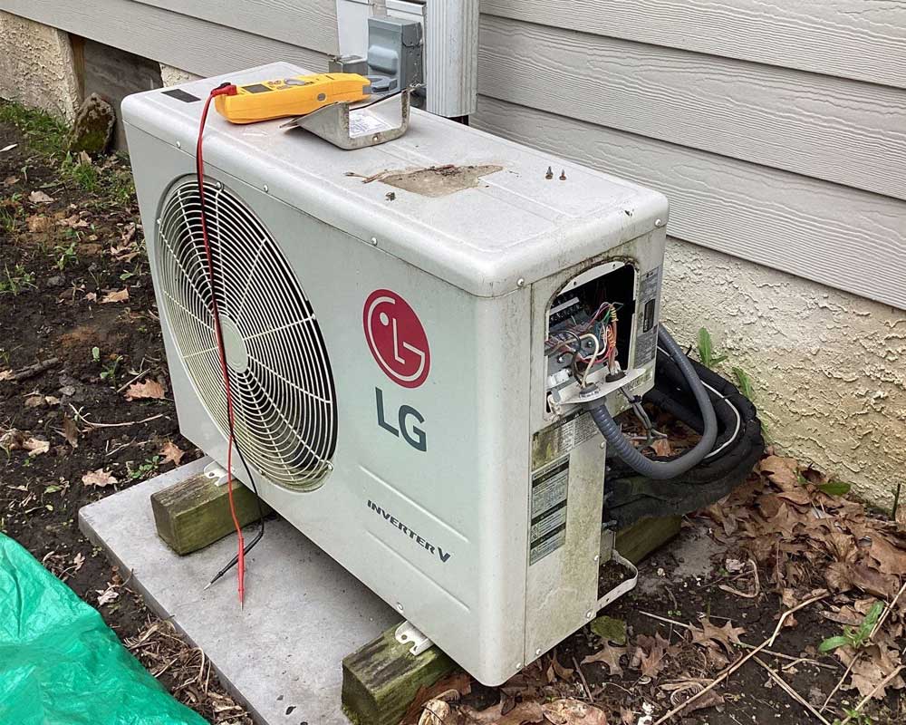 Old AC System by LG being diagnosed by HVAC technician