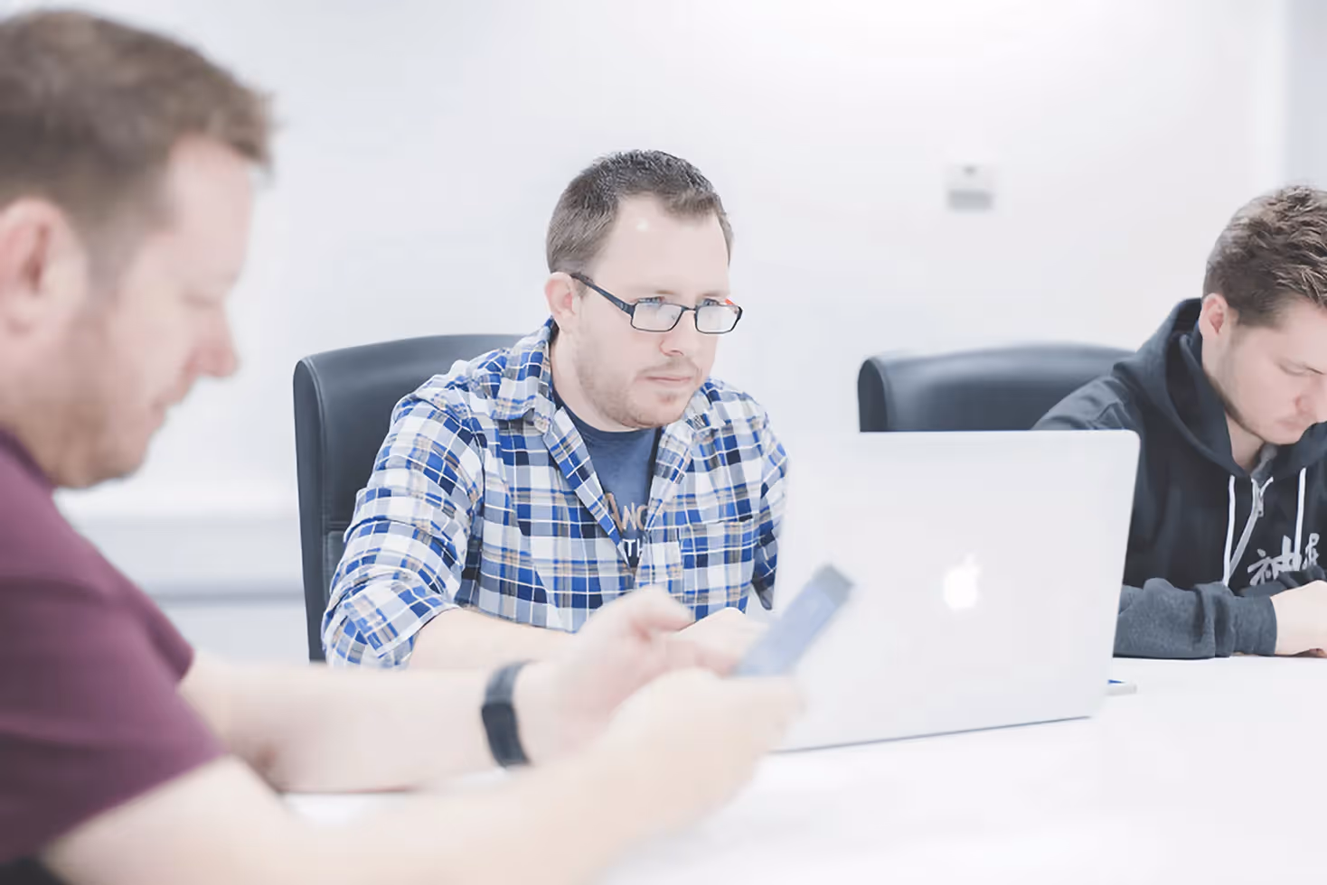 A man testing an app on his laptop, highlighting the importance of QA and testing in the app development process.