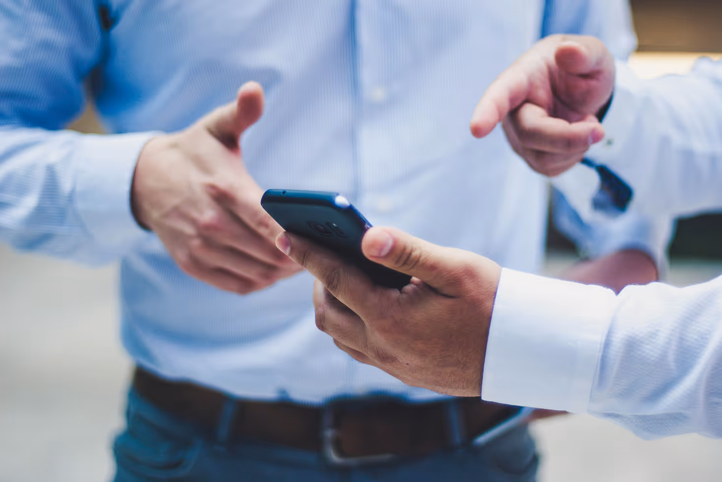 A man showing mobile app to another man