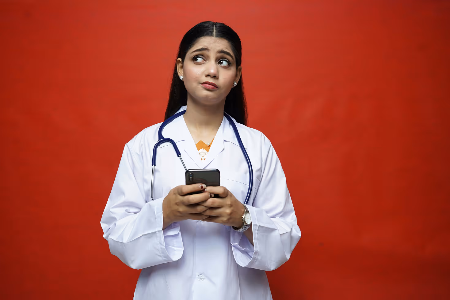 A doctor holding a phone