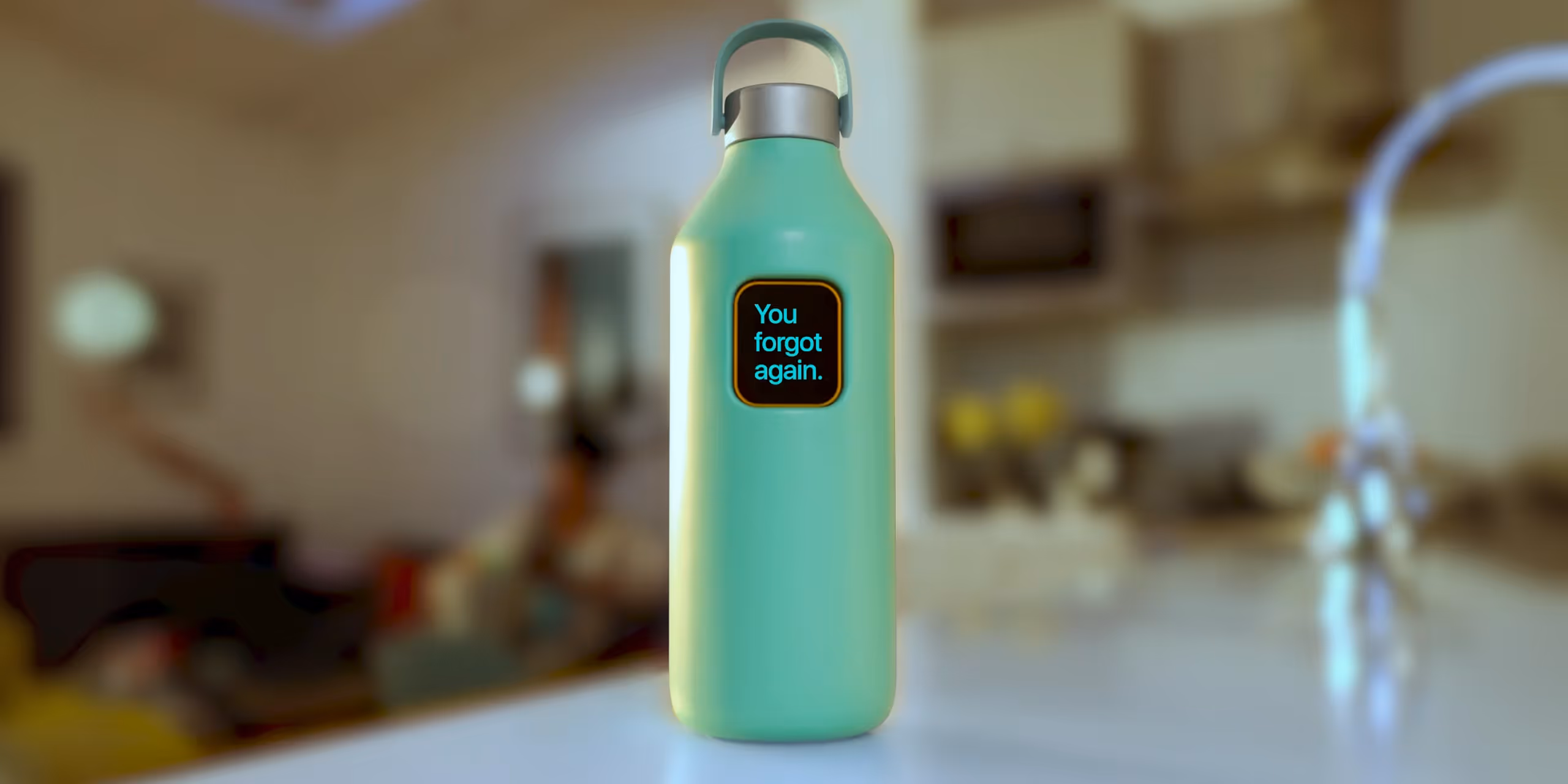 Light green water bottle with a screen that reads, 'You forgot again.' on a kitchen counter.
