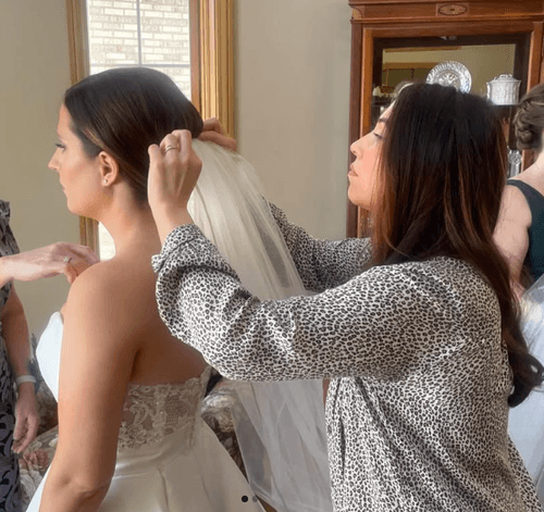Wedding beauty stylist working with the bride