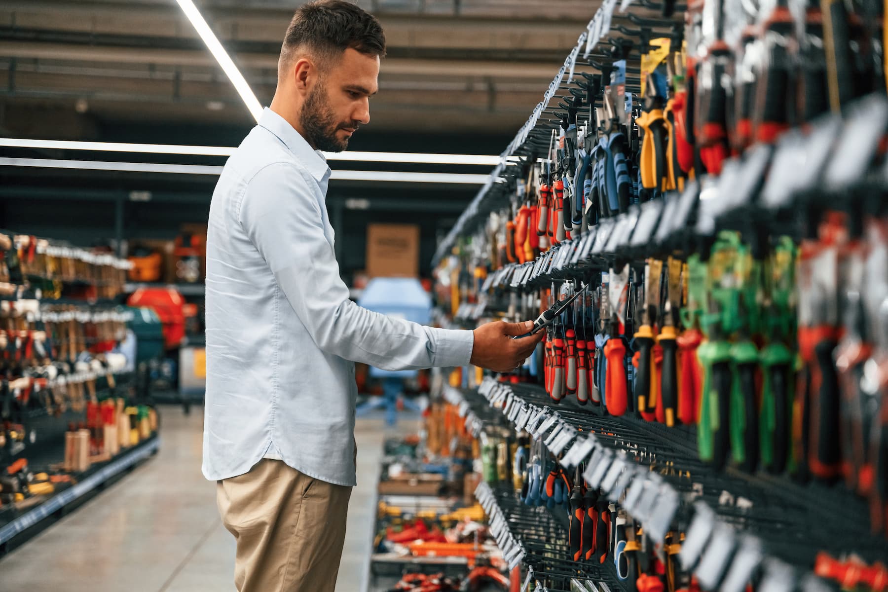 man searching for tools in home warehouse store