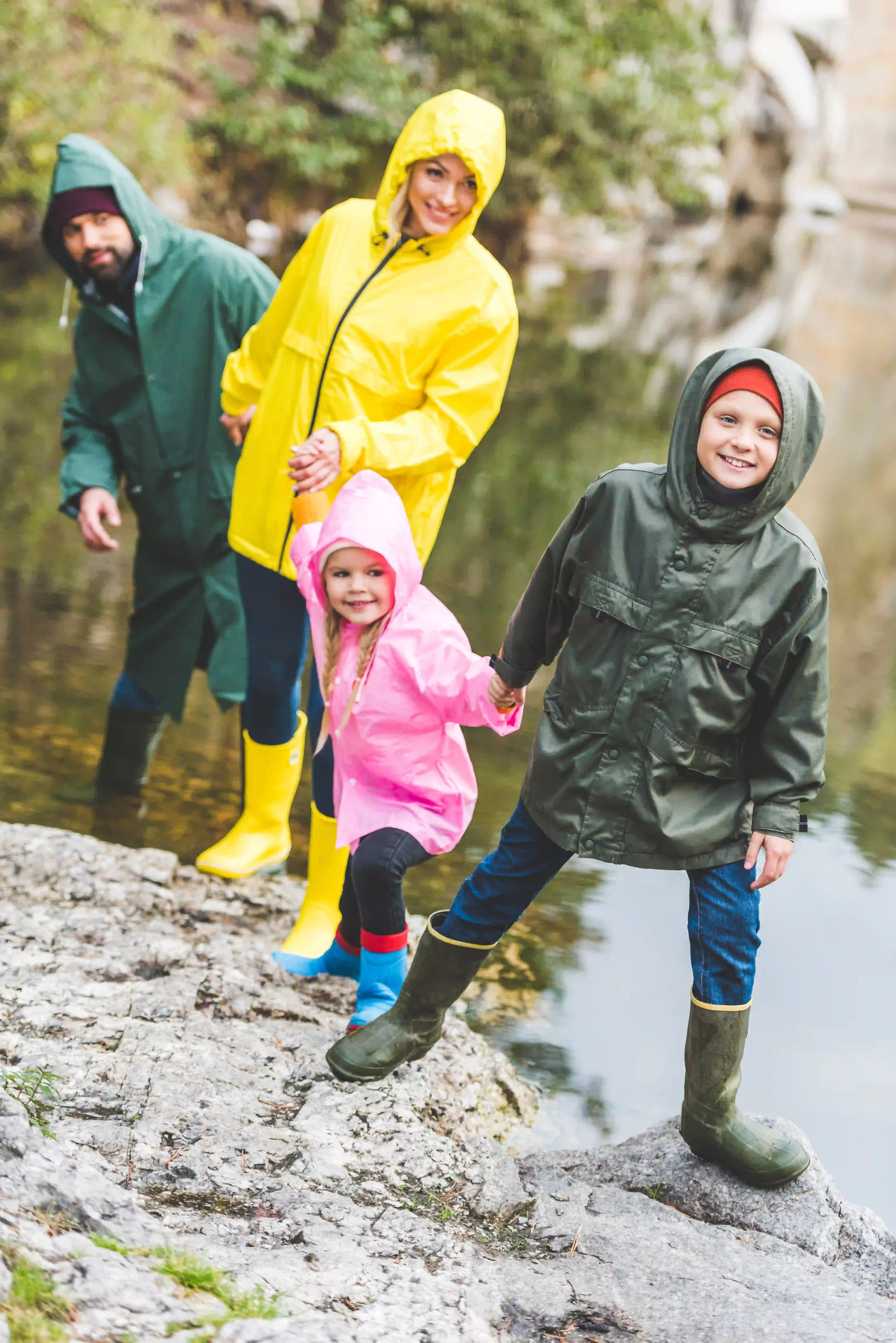 family in rain coats outdoors