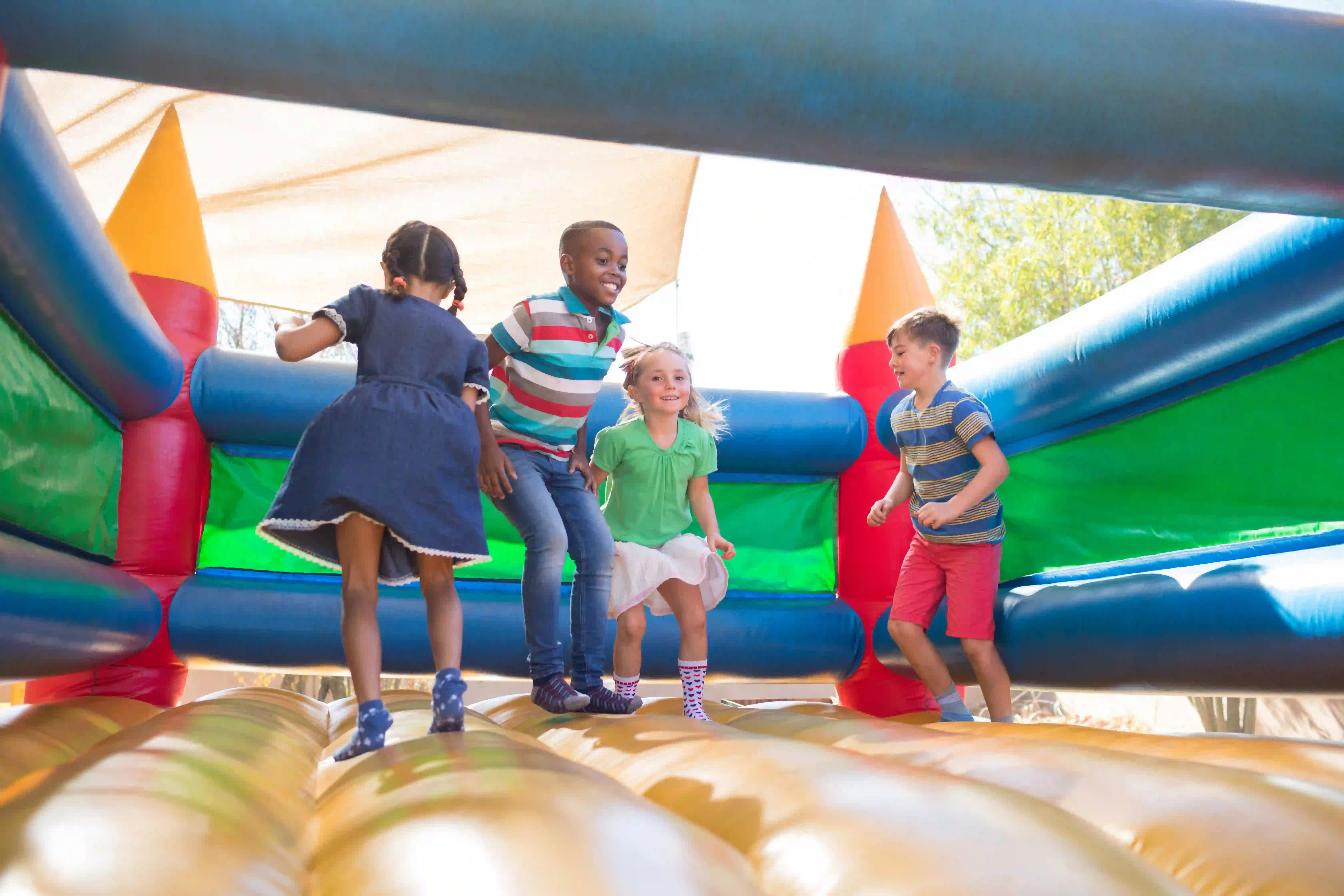children jumping in outdoor inflatable