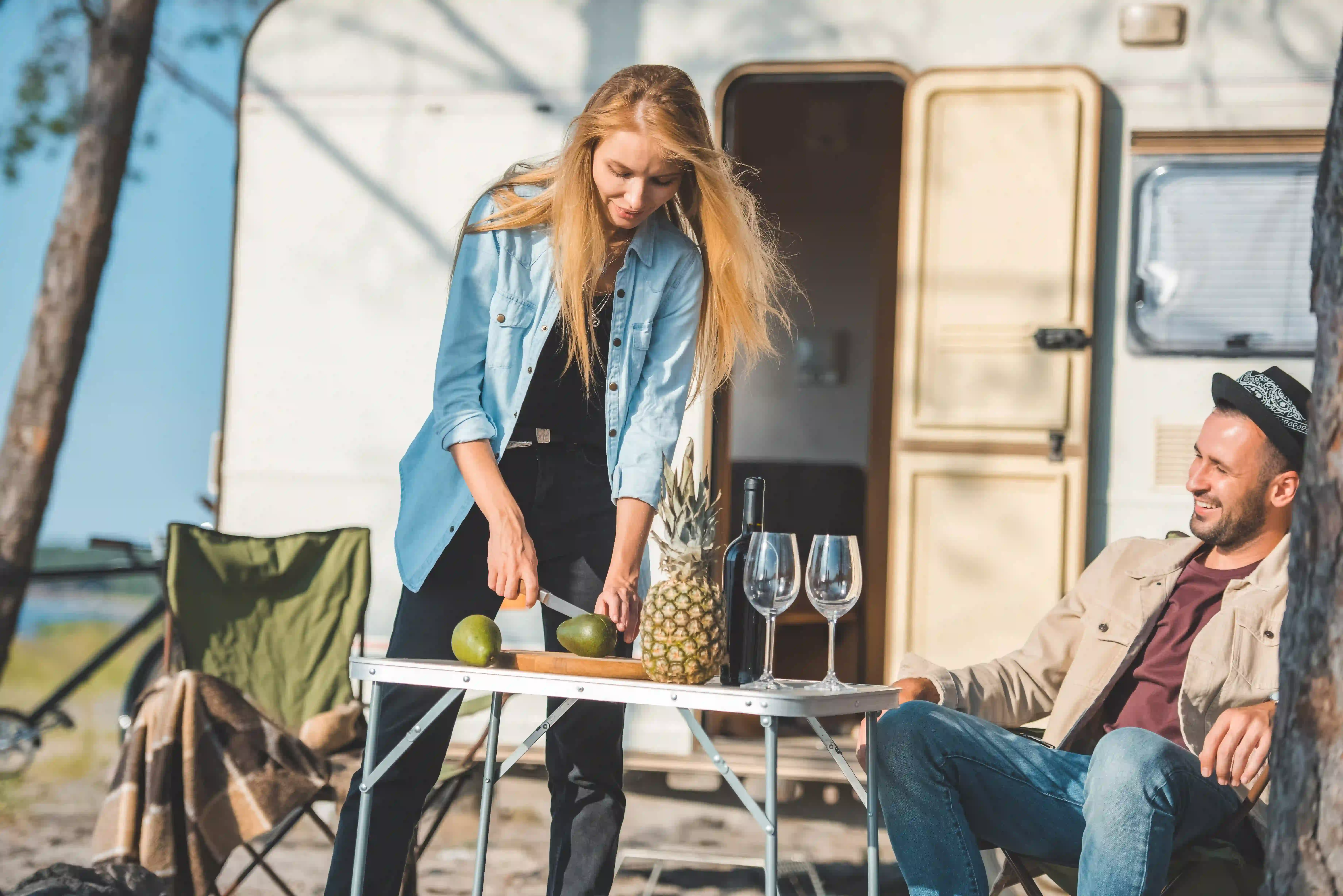 couple camping outdoor with folding table