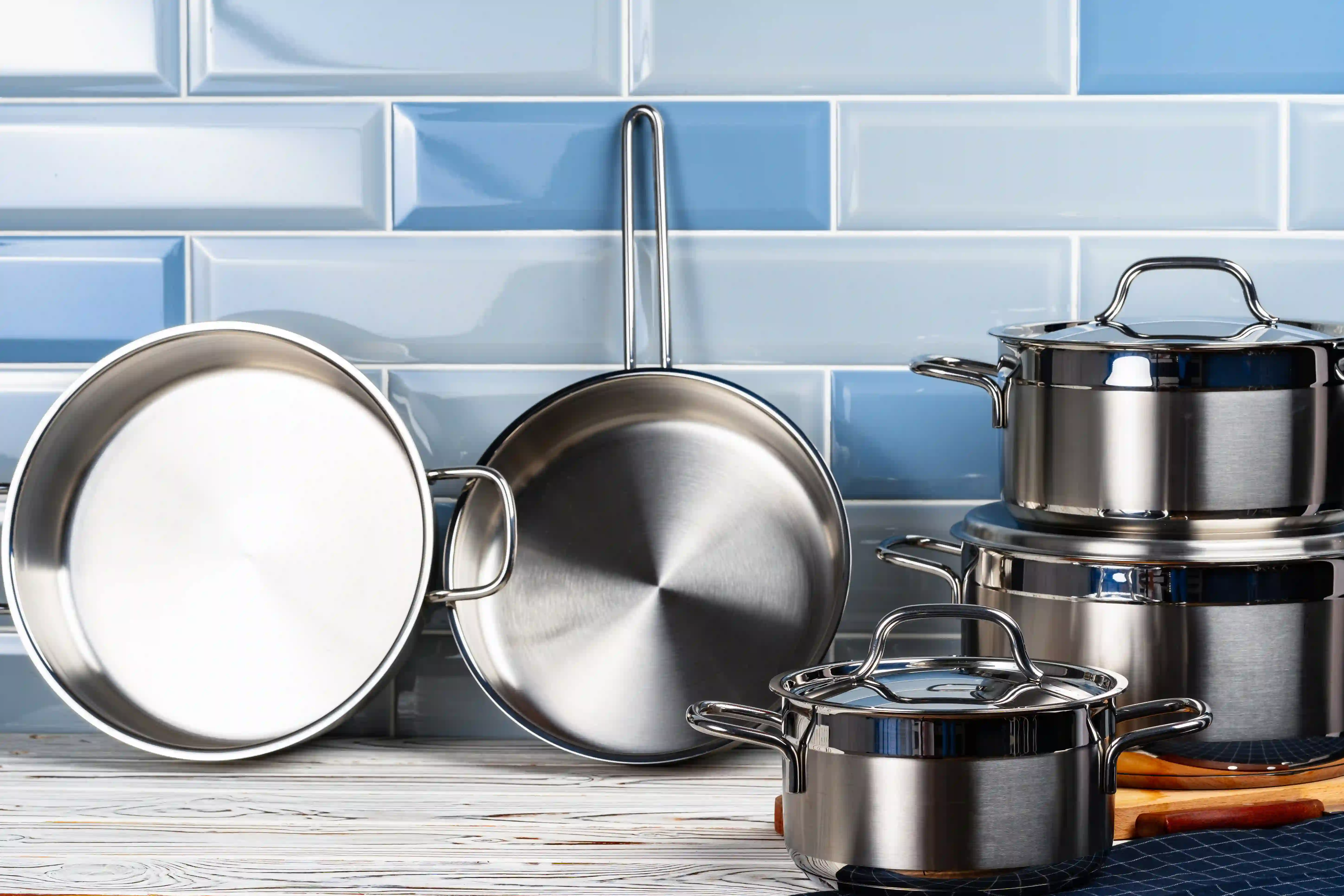 pots and pans stacked and lined up on counter