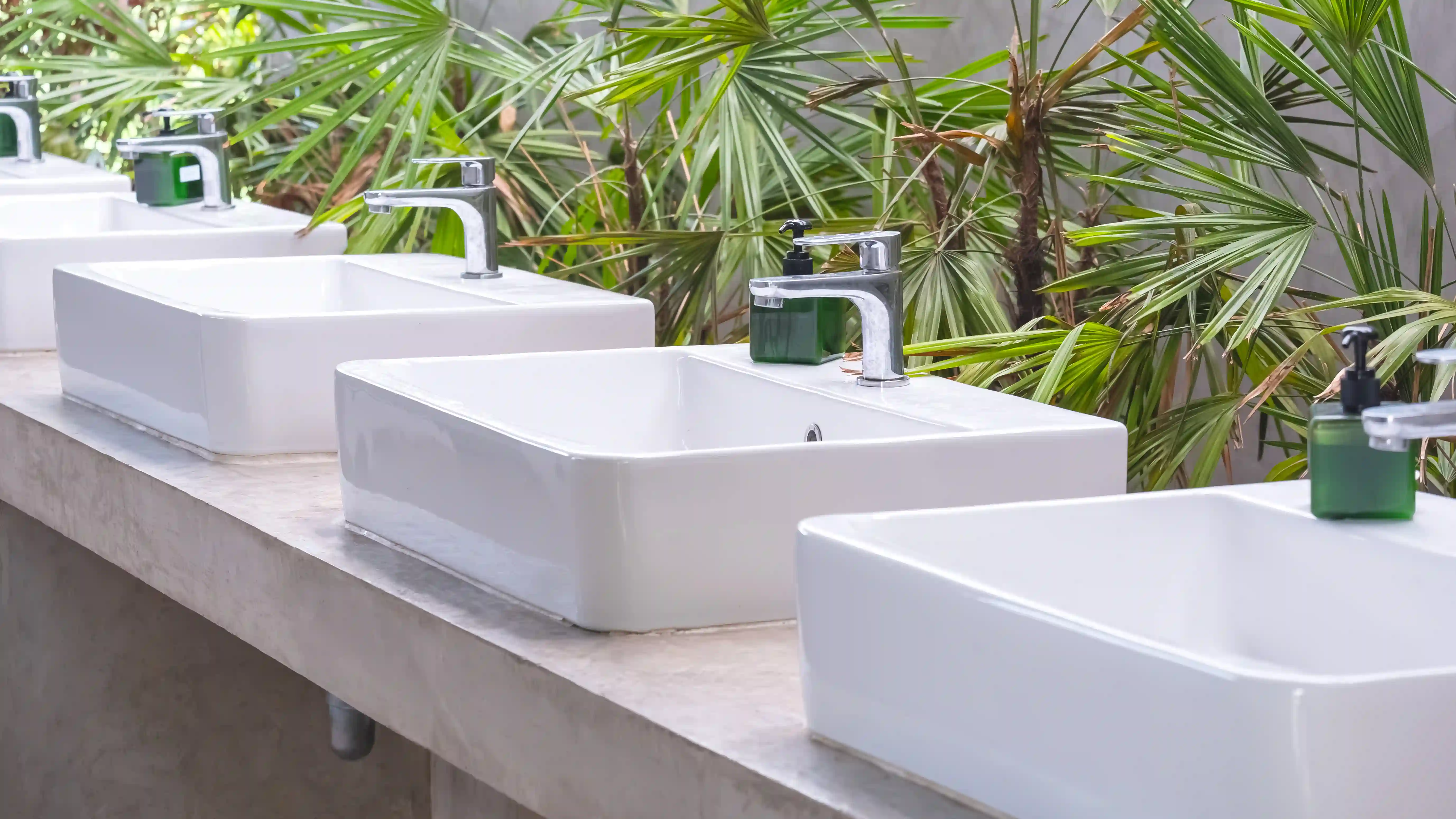 row of white ceramic sinks