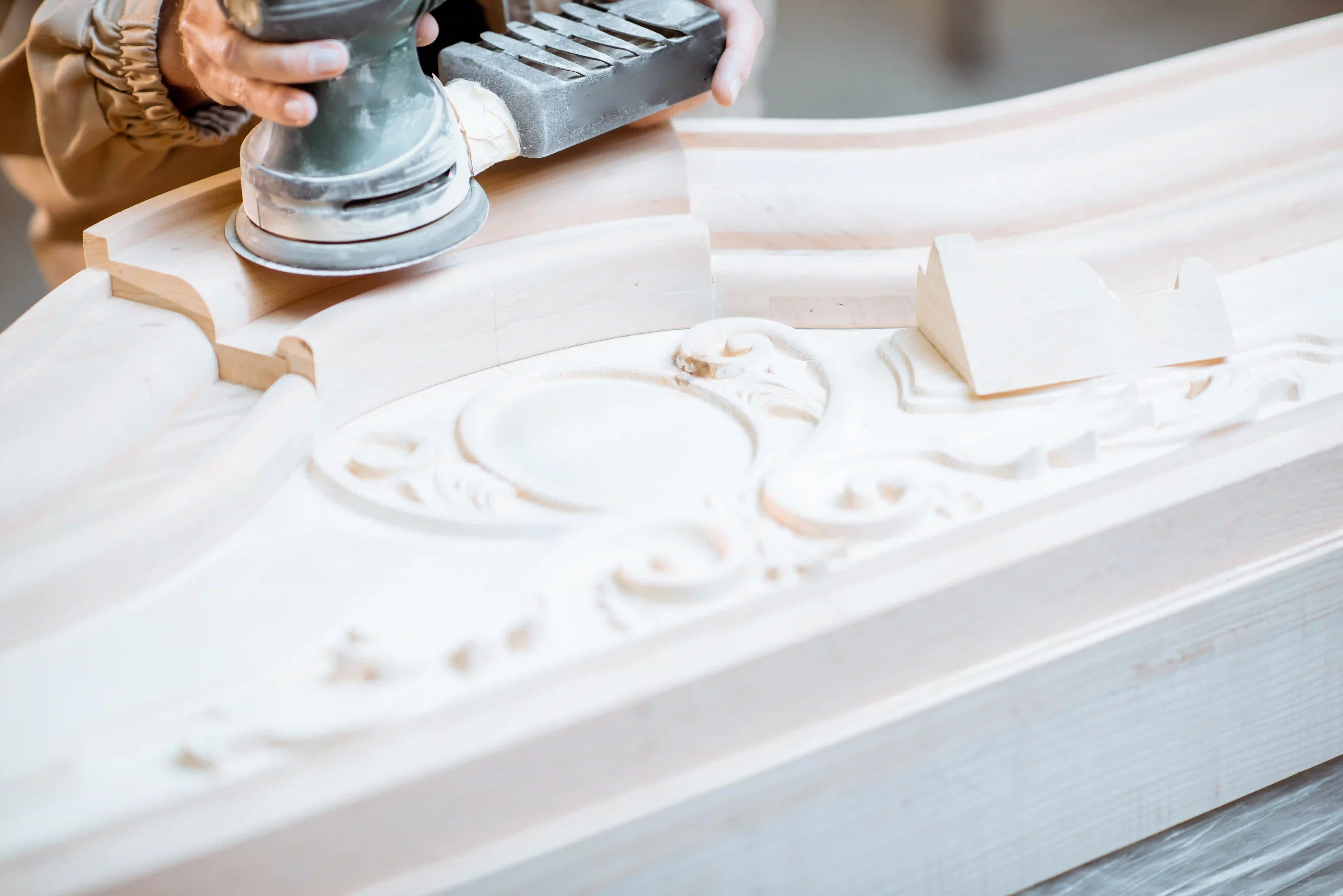 carpenter sanding moulding