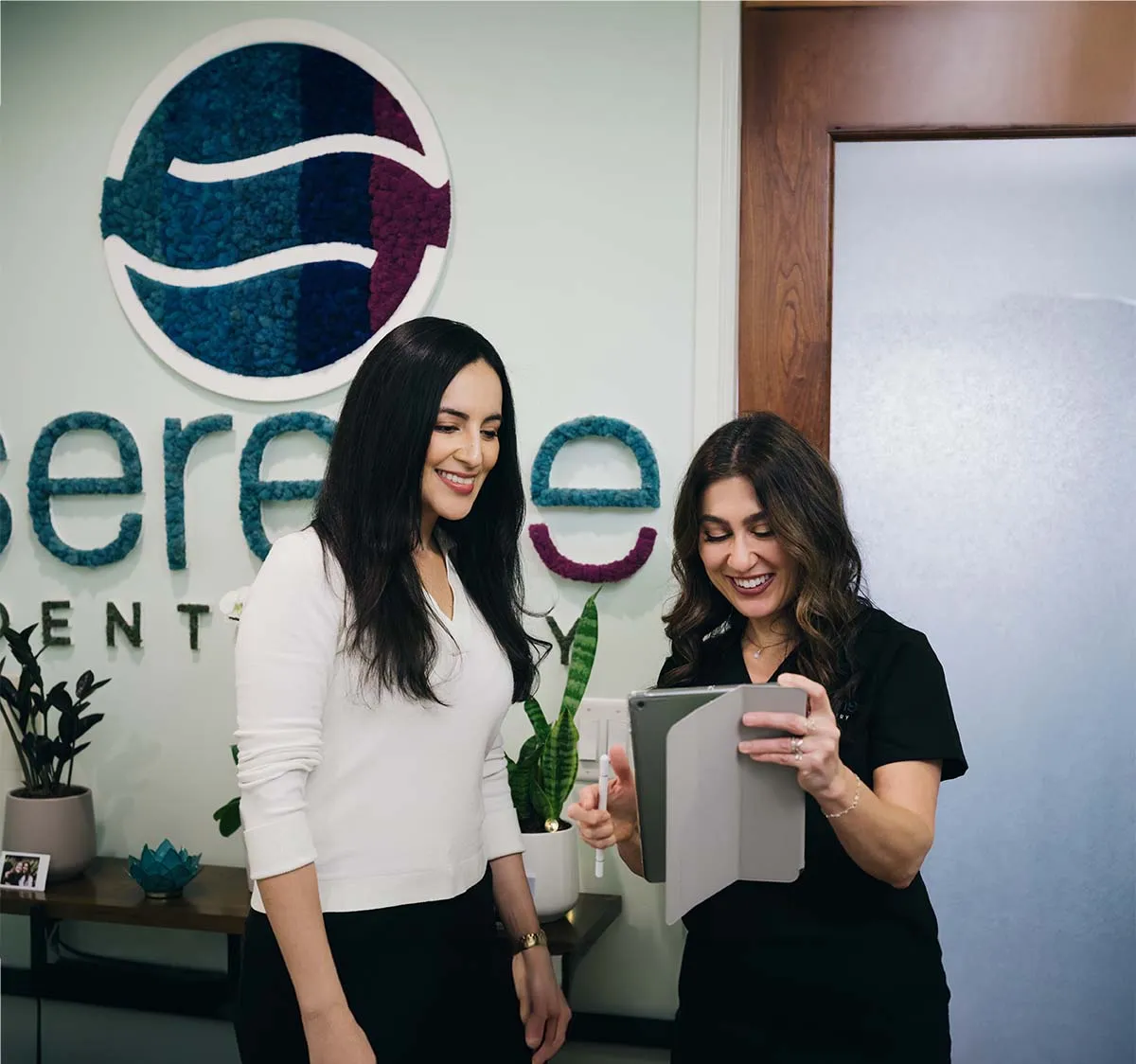 Dr. Efner reviewing a treatment plan on a tablet with a smiling patient at Serene Dentistry