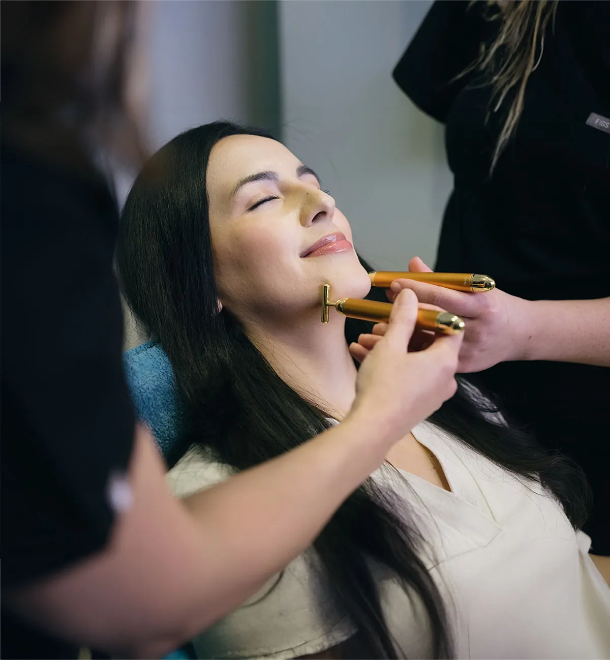 Facial roller being used on patient