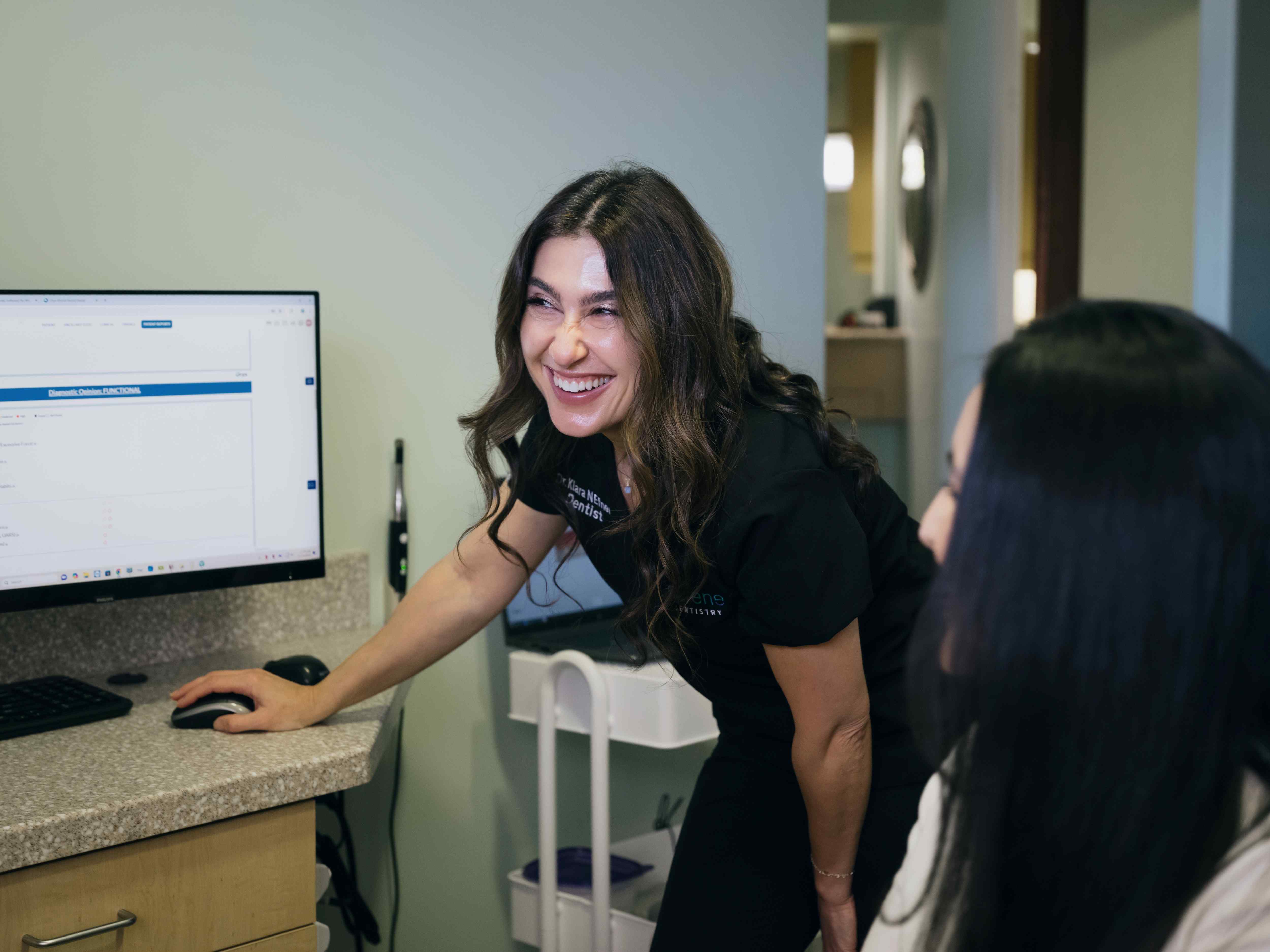 Our dentist at Serene Dentistry Ventura explaining the benefits of Dental Crowns to her patient