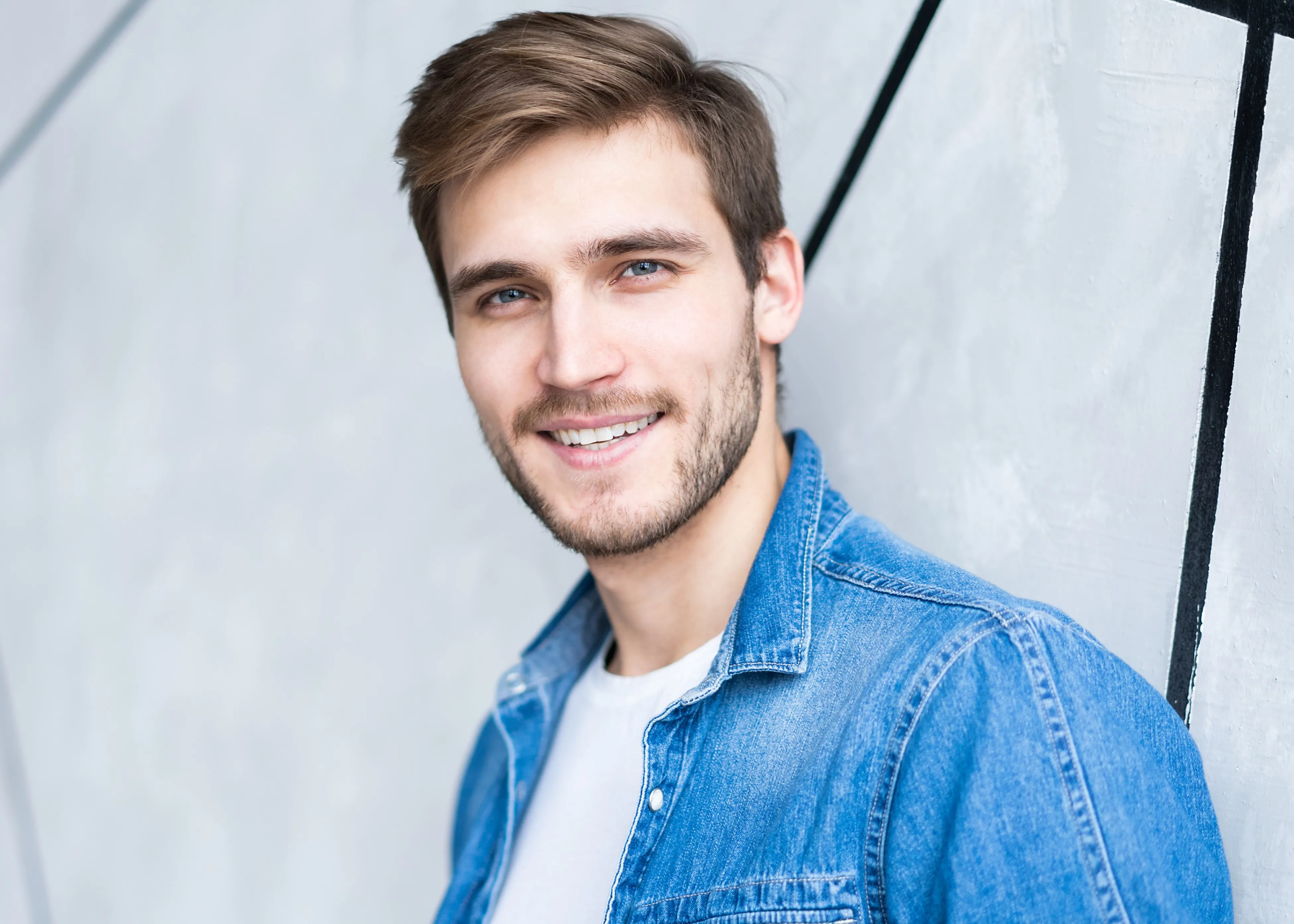 A man smiling with nice hair