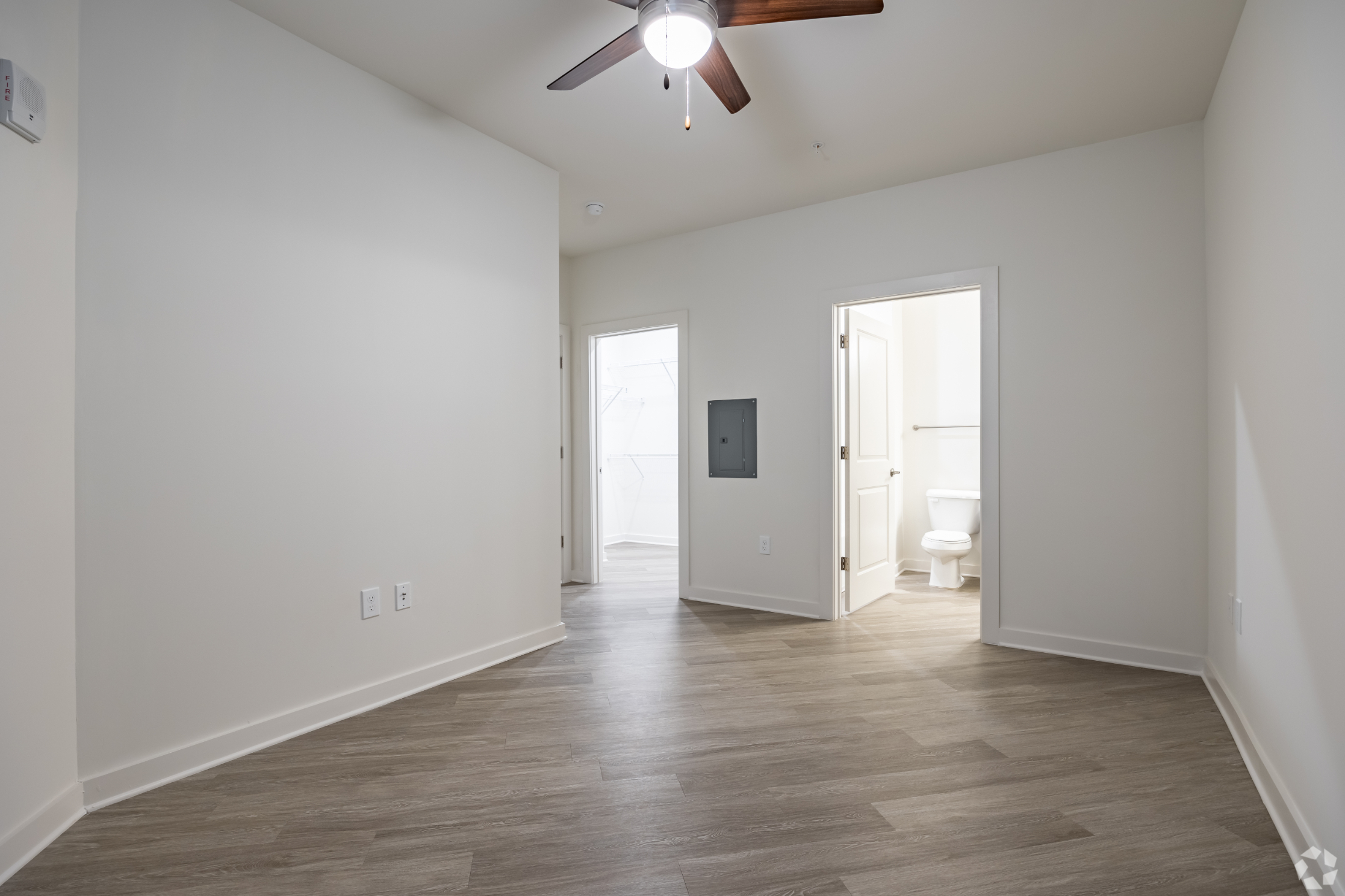 Bedroom with large closet and view of bathroom