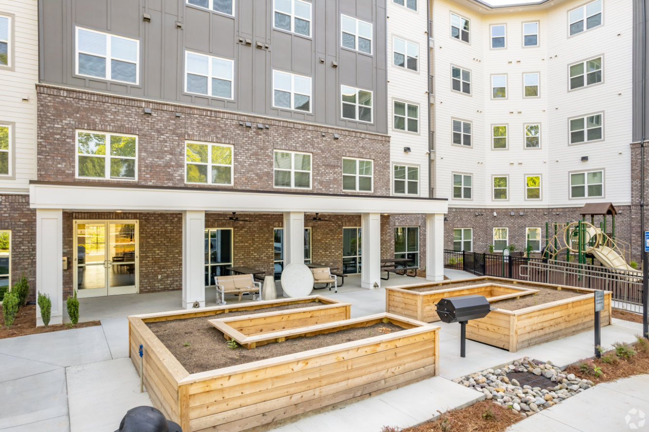 Community garden area with grills and playground