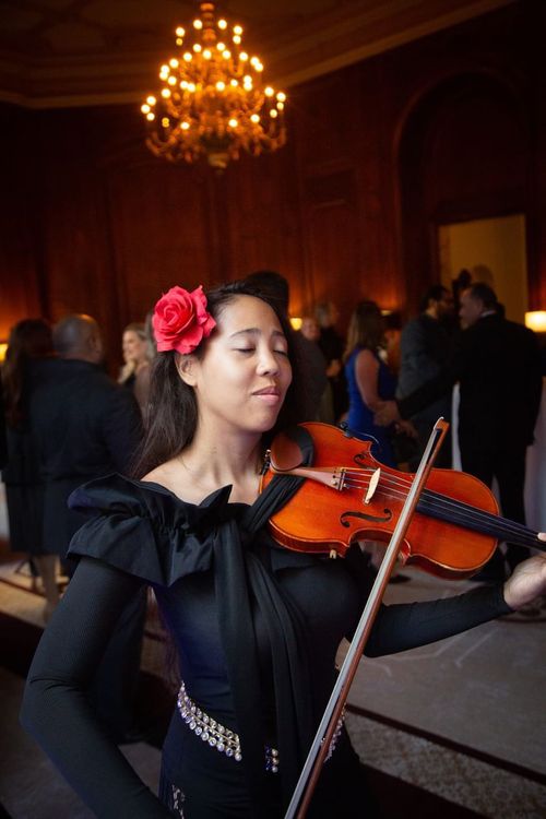 Baethoven violinist performing with eyes closed during indoor event