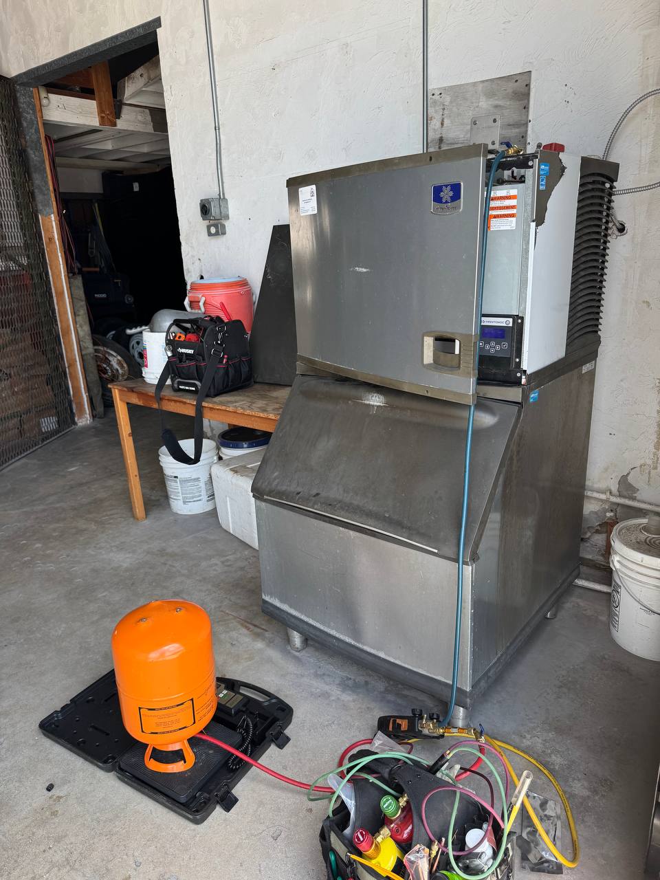 commercial ice maker being repaired
