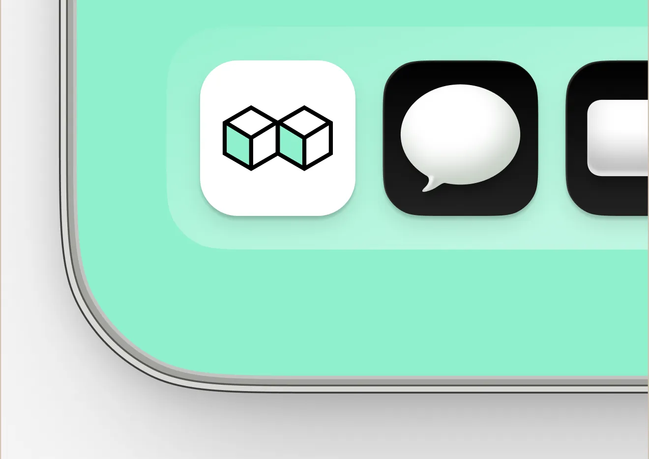 Close-up of smartphone icons on a mint green background, including overlapping cubes and a speech bubble