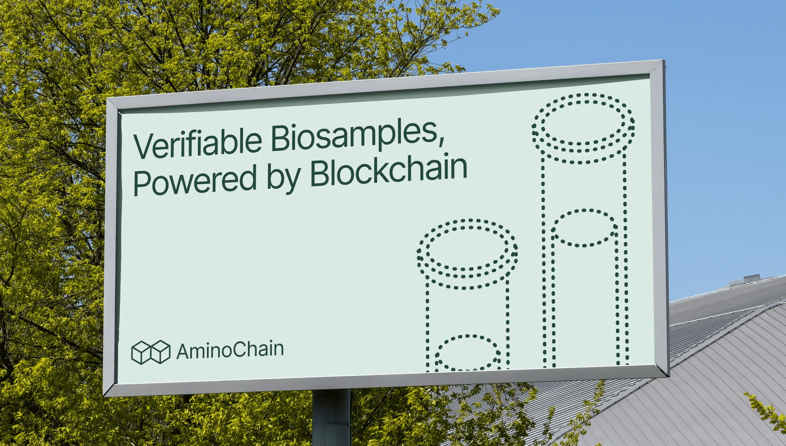 Outdoor billboard with ‘Verifiable Biosamples, Powered by Blockchain,’ AminoChain logo, and test tube illustrations.