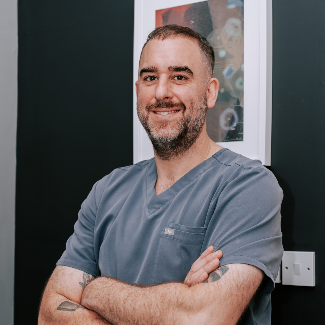 Dr Adam Watt, specialist endodontist in Glasgow, wearing clinical attire