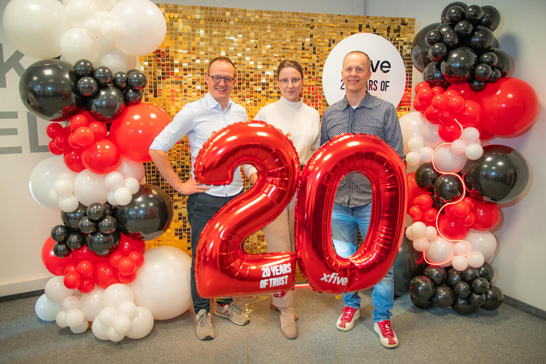A group of three people holding twenty number