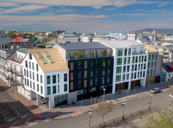Hotel Reykjavik Saga, a white and dark timber-clad building on a corner in central Reykjavik